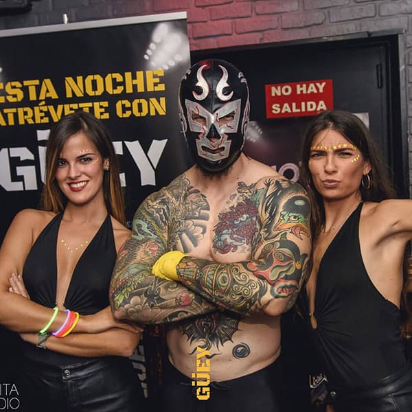 Three women with tattoos posing for a photo.