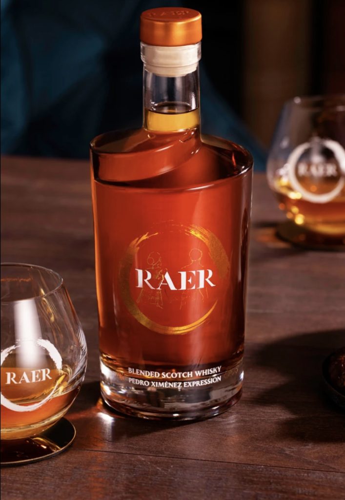 A bottle of RAER Blended Scotch Whisky Pedro Ximénez Expression sits on a table next to a glass.