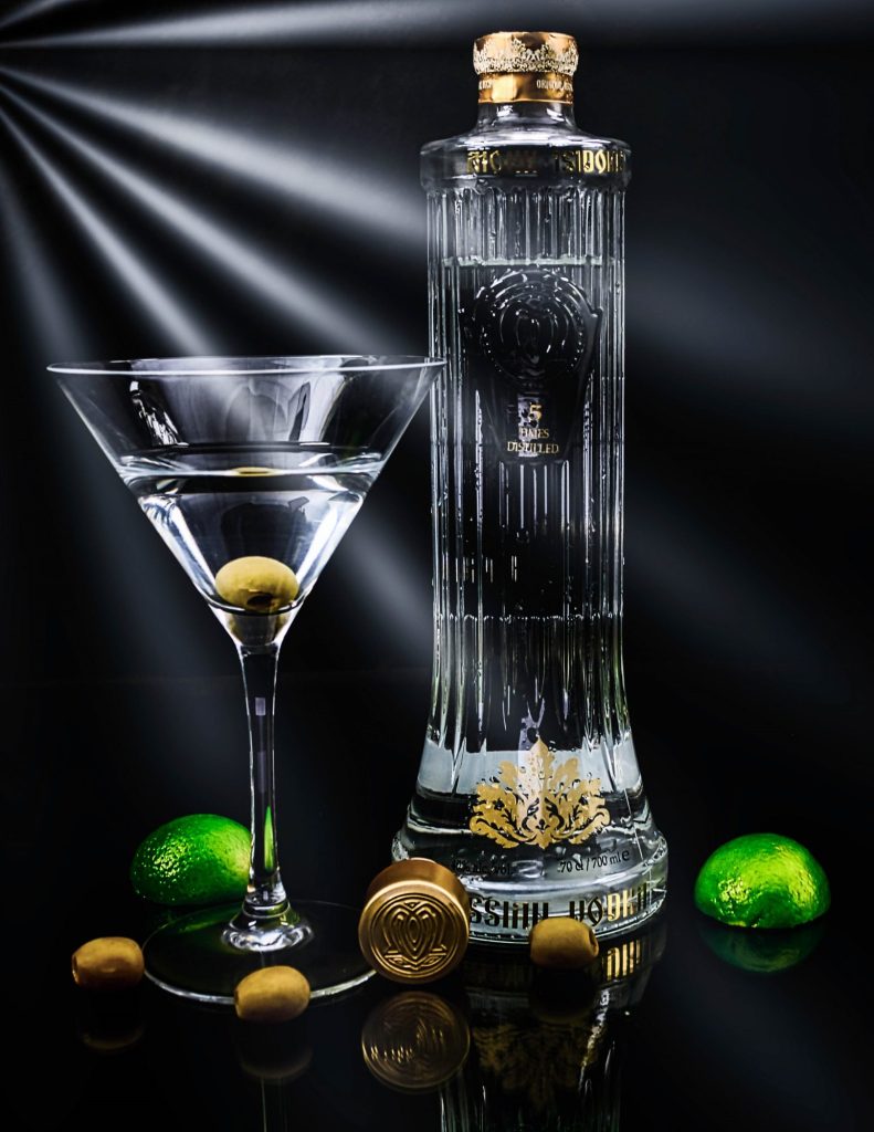 A martini glass with limes and a martini glass.
