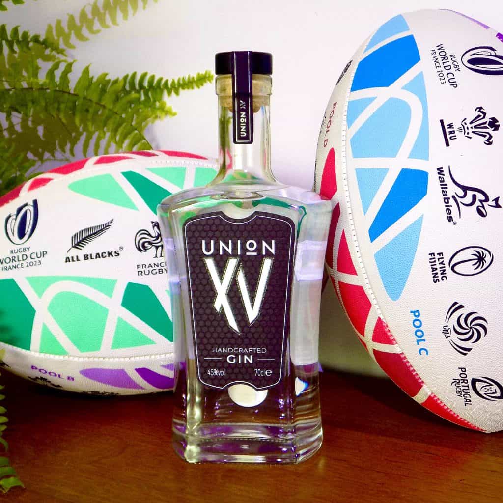 A bottle of Import placeholder for 20429 gin next to a rugby ball.